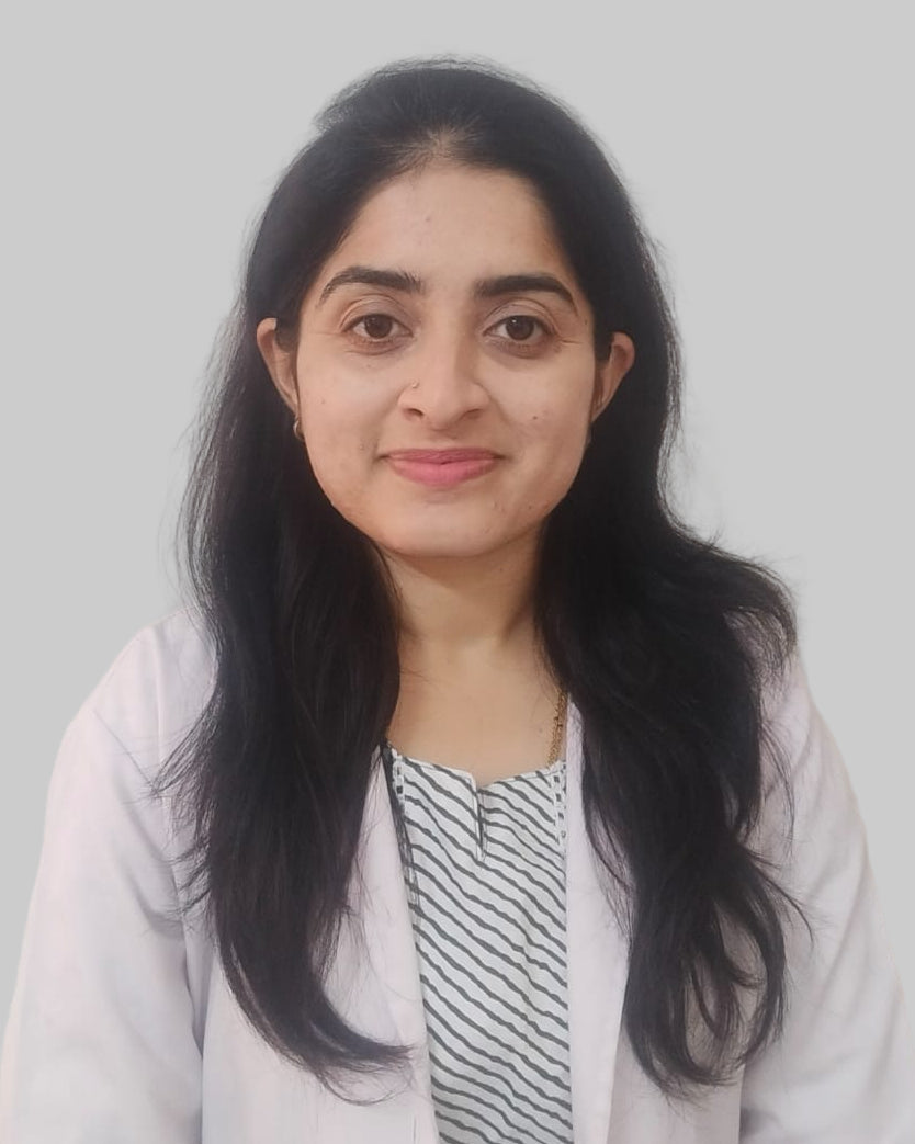 Dr Sharada Spoorthi Y wearing a light-colored lab coat against a plain background