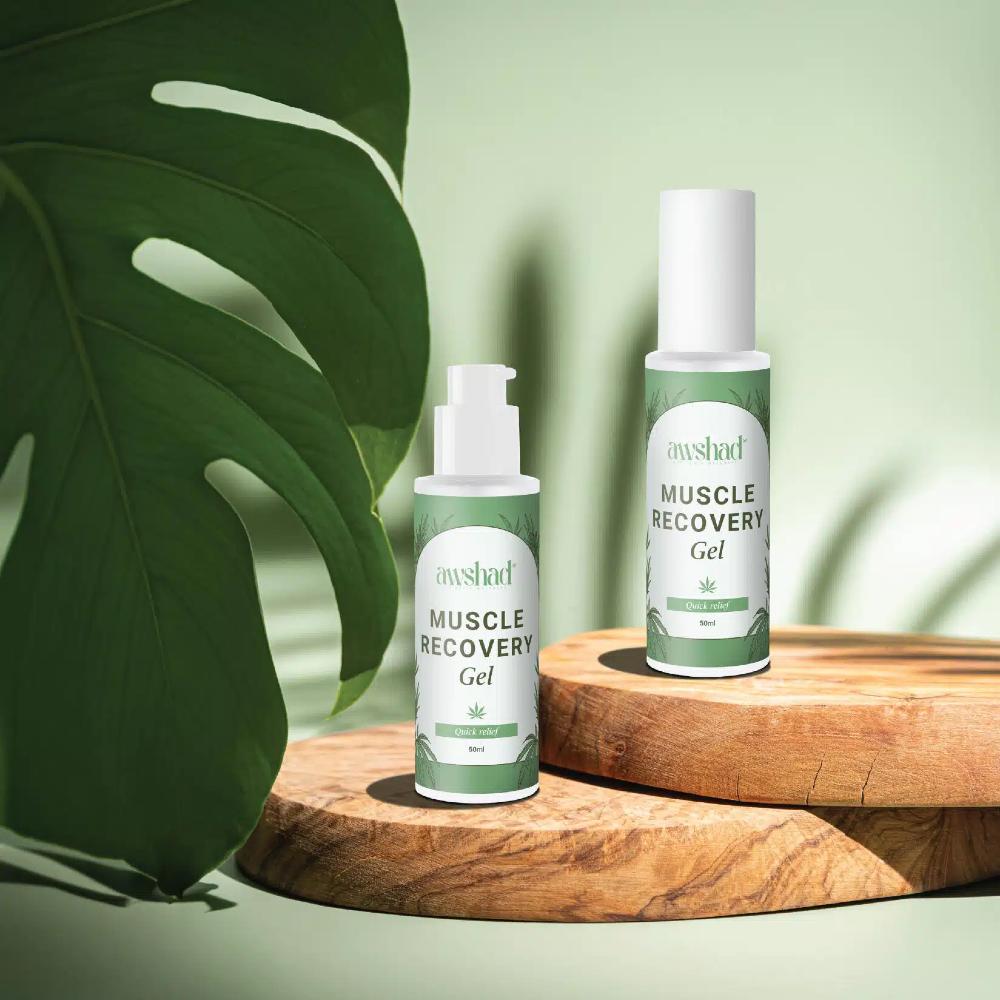 Two bottles of muscle recovery gel on wooden stands with green leafy background.