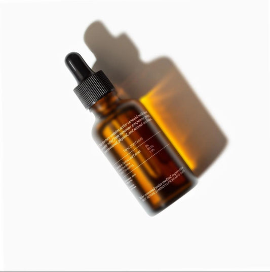Amber glass CBD Oil bottle with a white background and a prominent shadow.