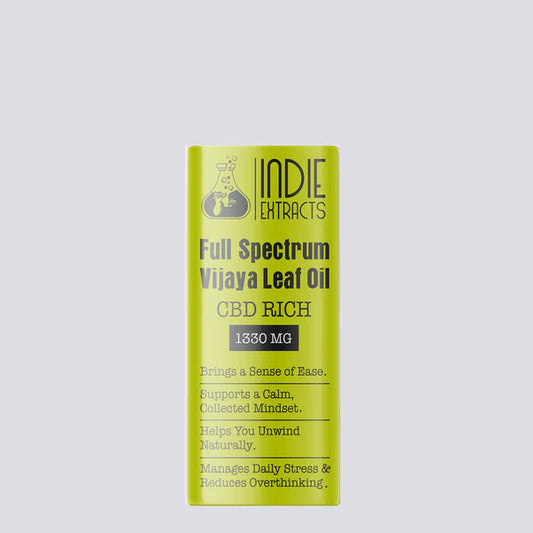 Yellow packaging of Indie Extracts Full Spectrum Vijaya Leaf Oil on a light gray background