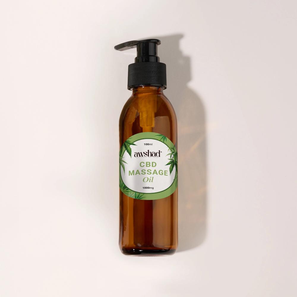 Amber bottle of CBD massage oil with pump dispenser on a light background.