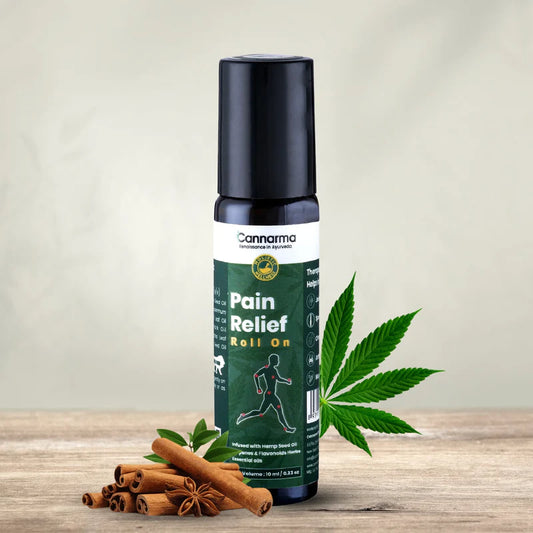 Bottle of Cannarma Pain Relief Roll On with hemp leaves and cinnamon sticks.