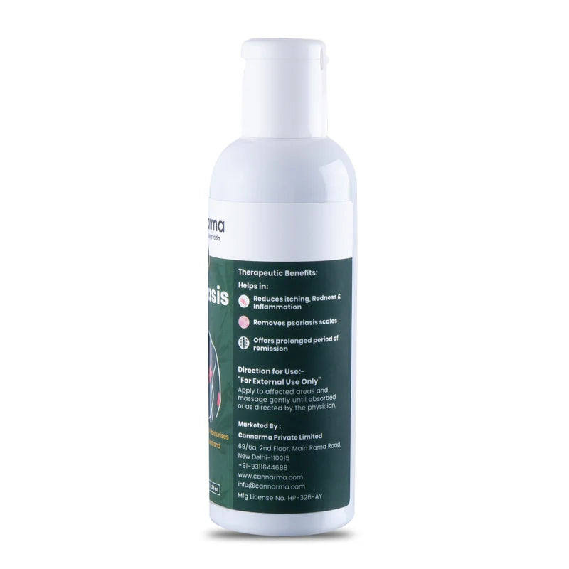 White plastic bottle with a dark green label listing therapeutic benefits and usage directions for cannarma psoriasis hemp oil.