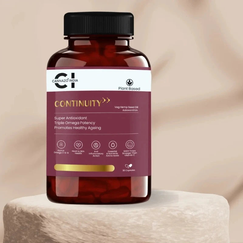 a bottle of astaxanthin + hempseed oil supplement pills on a stone.