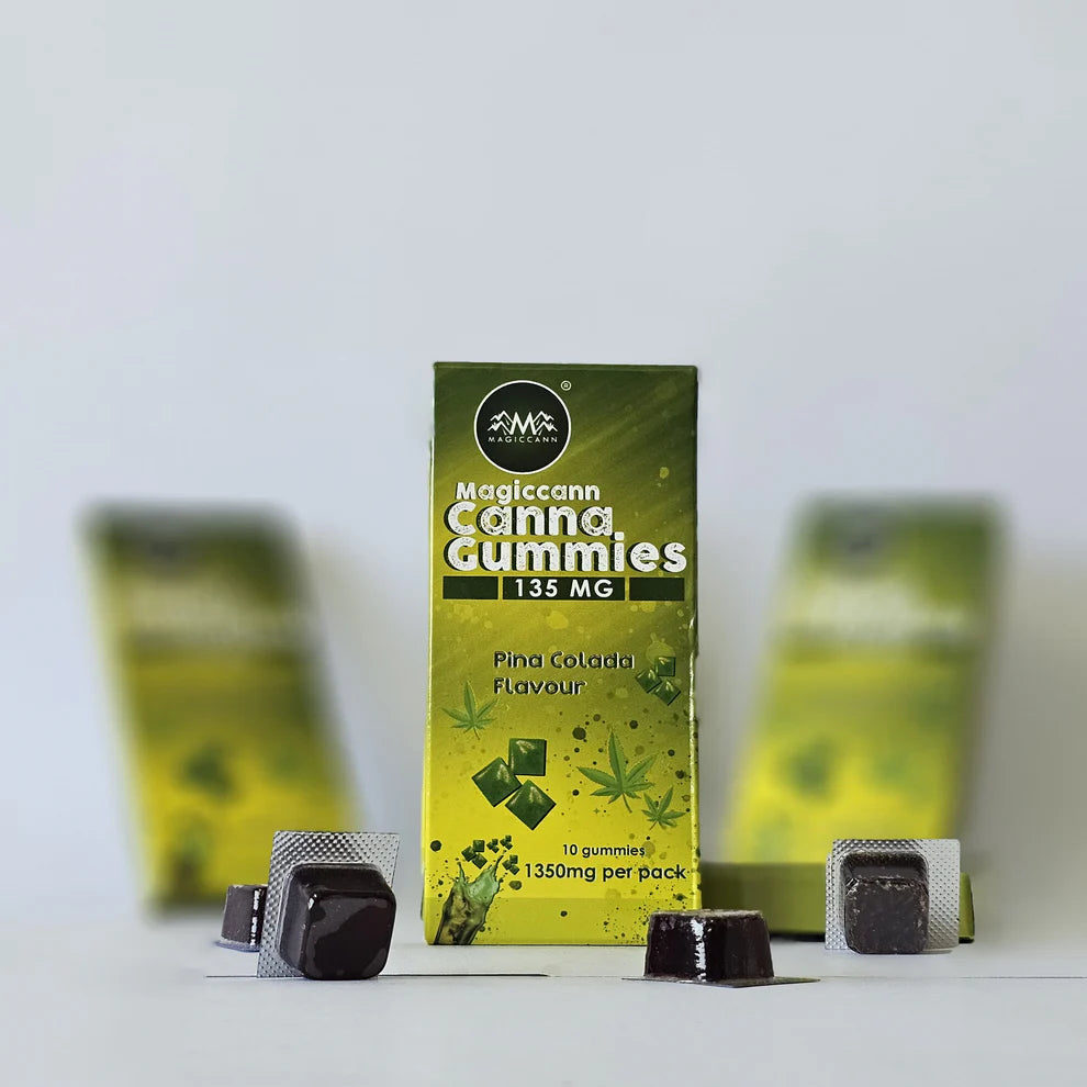 Box of Magiccann Cannabis Infused CBD THC Gummies with dark gummies in blister packs.