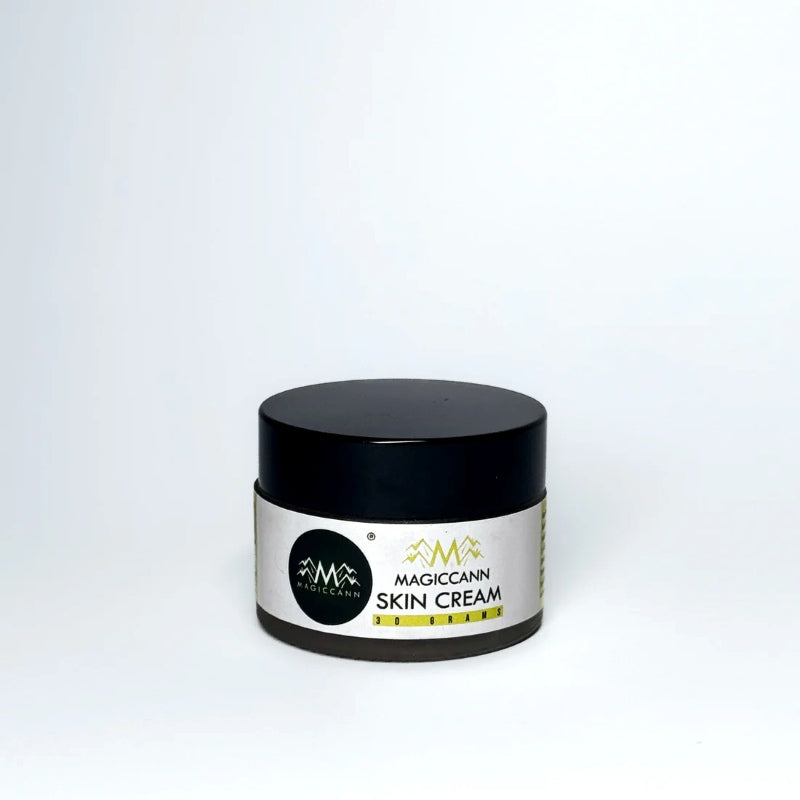 A jar of skin cream with a black lid and a white label, displaying the text "MAGICCANN HEMP SKIN CREAM 30 GRAMS."