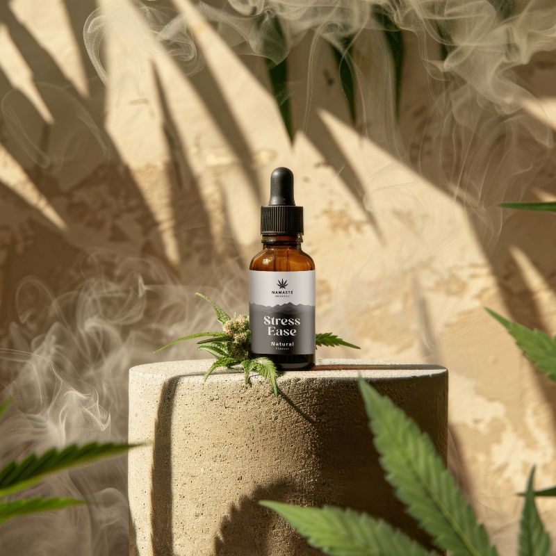 Full spectrum CBD Oil bottle labeled 'Stress Ease' with cannabis leaves on a textured surface, surrounded by smoke and foliage.