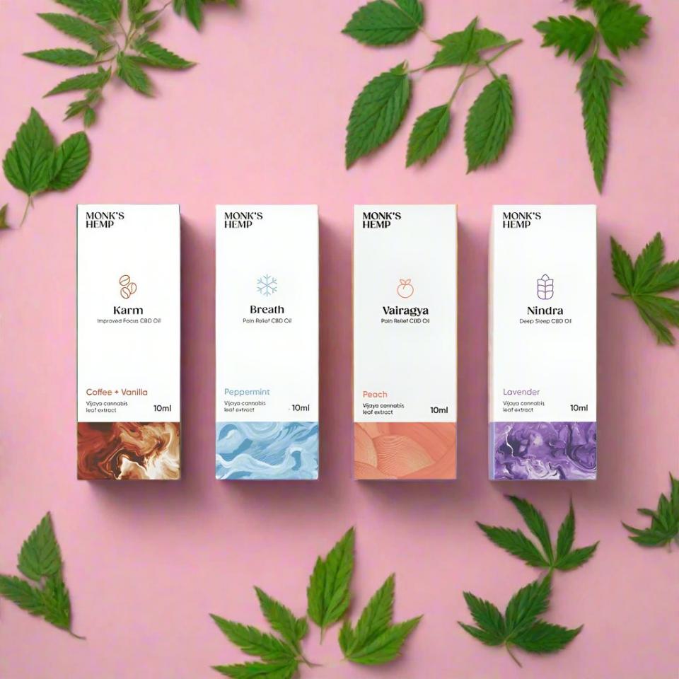 Four boxes of Monk's Hemp CBD oils with different names, flavors, and color patterns