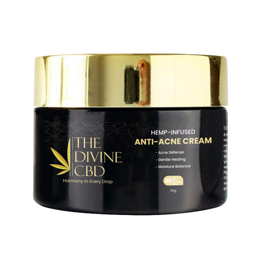 A container of "THE DIVINE CBD HEMP-INFUSED ANTI-ACNE CREAM" with a gold lid and dark glossy body.