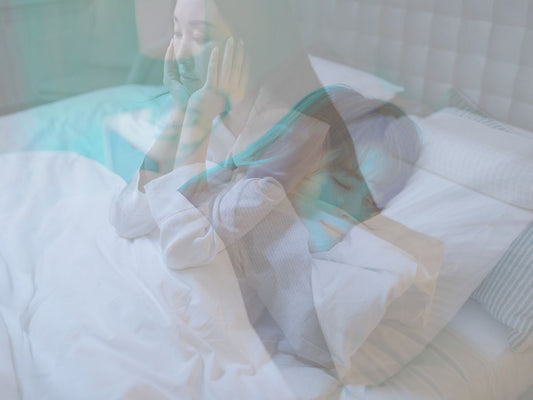 Overlay of a person sitting and sleeping on a bed, creating a dreamy effect.