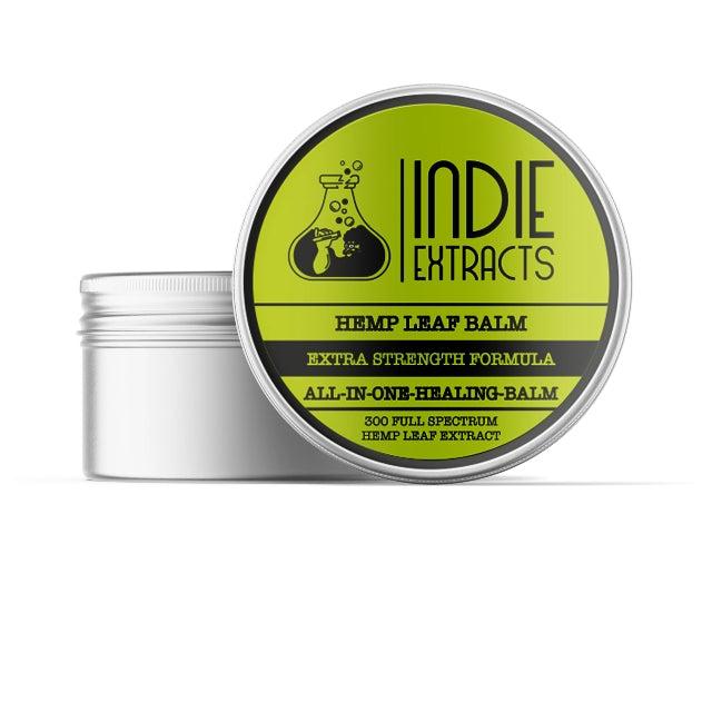 Round container of Indie Extracts CBD Balm with a greenish-yellow label and black text.