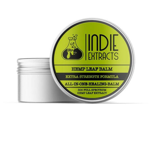 Round container of Indie Extracts CBD Balm with a greenish-yellow label and black text.