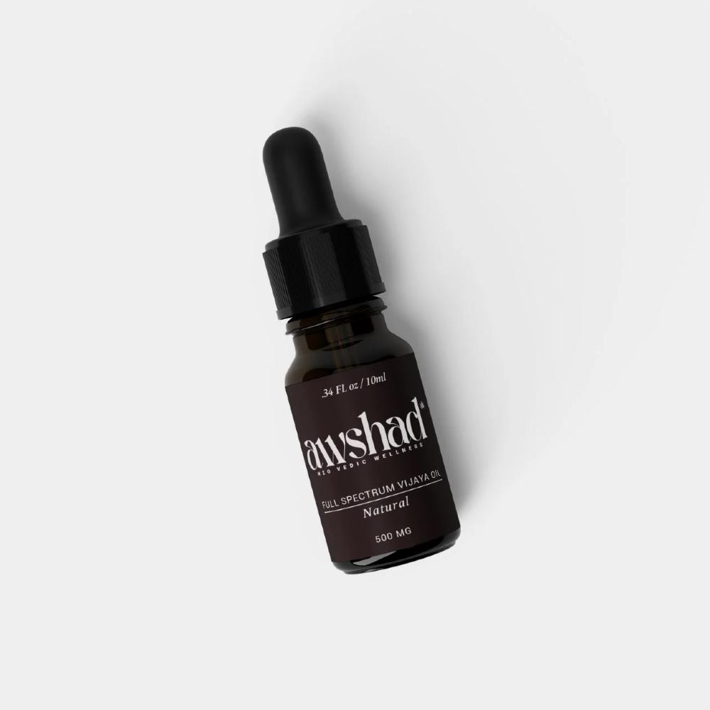 Dropper bottle of "full spectrum vijaya CBD oil" on white background.