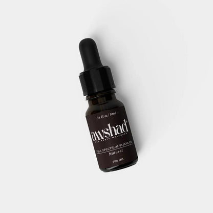 Dropper bottle of "full spectrum vijaya CBD oil" on white background.