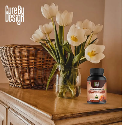 Vase of white tulips on a wooden surface with a bottle of sea buckthorn oil next to it.
