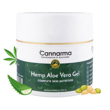 Load image into Gallery viewer, Cannarma Hemp Aloe Vera Gel with Hyaluronic Acid in a green and white jar on a wooden surface with aloe vera and cannabis leaves nearby.
