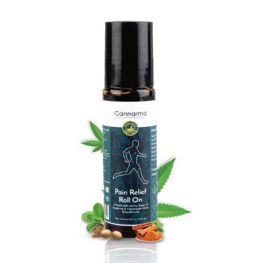A black-capped roll-on bottle labeled "Cannarma Pain Relief Roll On" stands amidst illustrations of herbs and leaves, indicating natural ingredients.