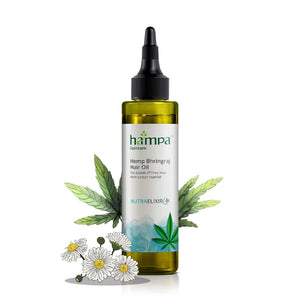 Hemp Bhringraj Hair Oil bottle with leaves and flowers on a white background