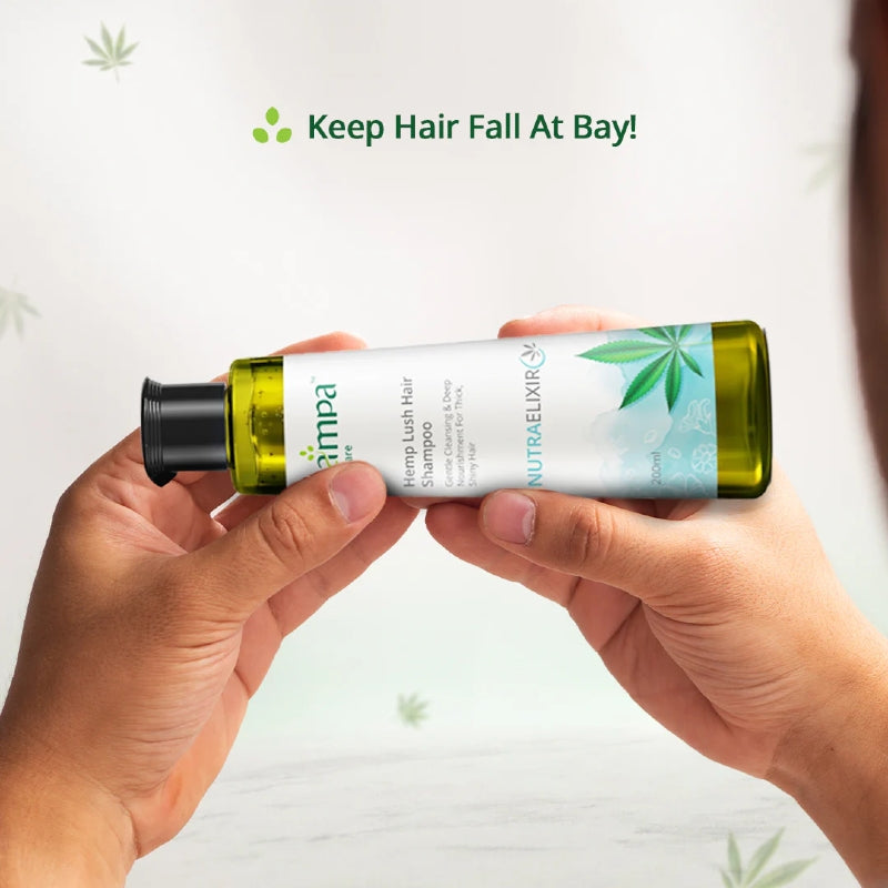 Person holding a bottle of hemp-based shampoo with a visible brand label on a light background.