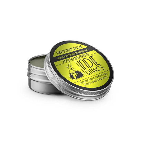 Open tin container of Indie Extracts CBD balm with a yellow and black label.