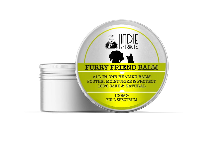 A silver tin container with a partially open lid labeled "Furry Friend cbd Balm" by Indie Extracts.