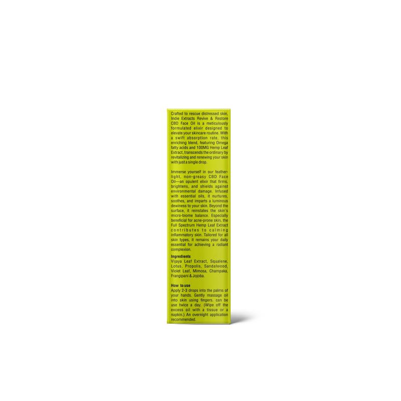 Bright yellow-green rectangular product box with black text detailing "Indie Extracts Revive And Restore CBD Face Oil."
