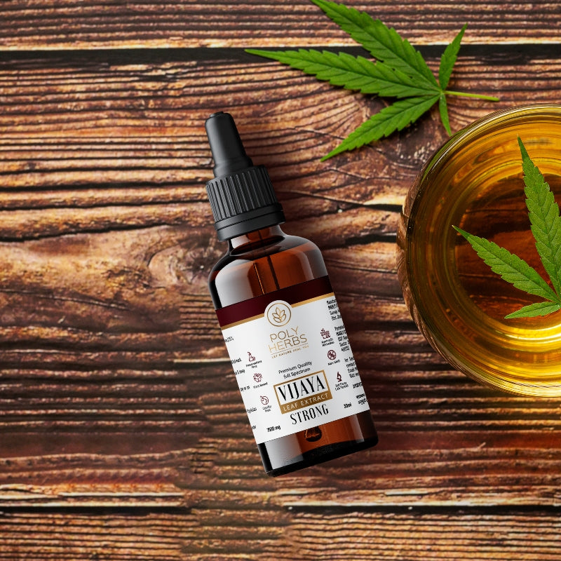 CBD oil bottle with a dropper on a wooden surface with cannabis leaves.