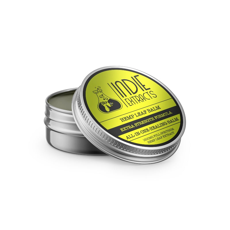 A tin of Indie Extracts Pet CBD Balm with a partially opened lid showing a green balm inside.