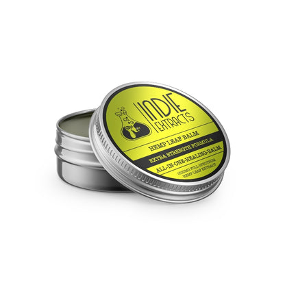 A tin of Indie Extracts Pet CBD Balm with a partially opened lid showing a green balm inside.