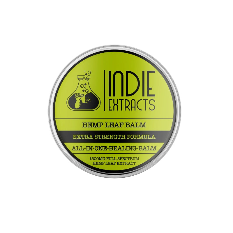 Circular label of "Indie Extracts All in One Hemp Leaf CBD Balm" on a metal container with a lime green background and black text and graphics.