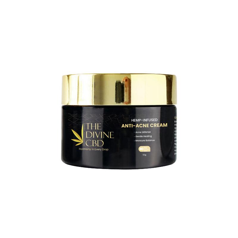 Container of "The Divine CBD" hemp-infused anti-acne cream with gold lid and black container.

