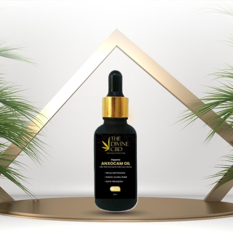 Paarmi Cares' "The Divine CBD" Anxocam Oil bottle with gold cap, on a gold reflective surface with geometric white and gold triangular frames in the background.