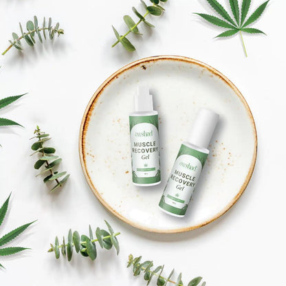 Two bottles of awshad cbd muscle recovery gel with cannabis leaves on a white background.