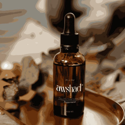 Bottle of Awshad full spectrum CBD oil on a textured background
