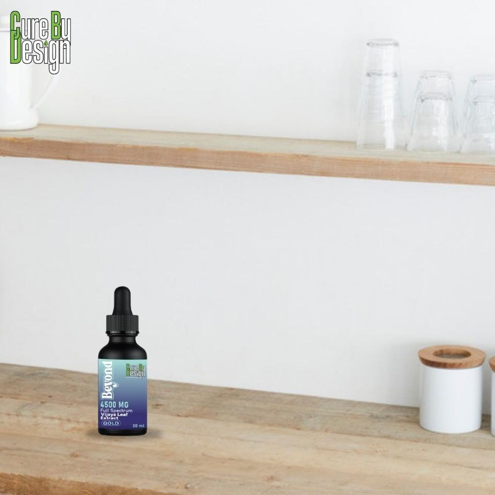 Cure By Design CBD oil bottle on a wooden surface with a white wall background