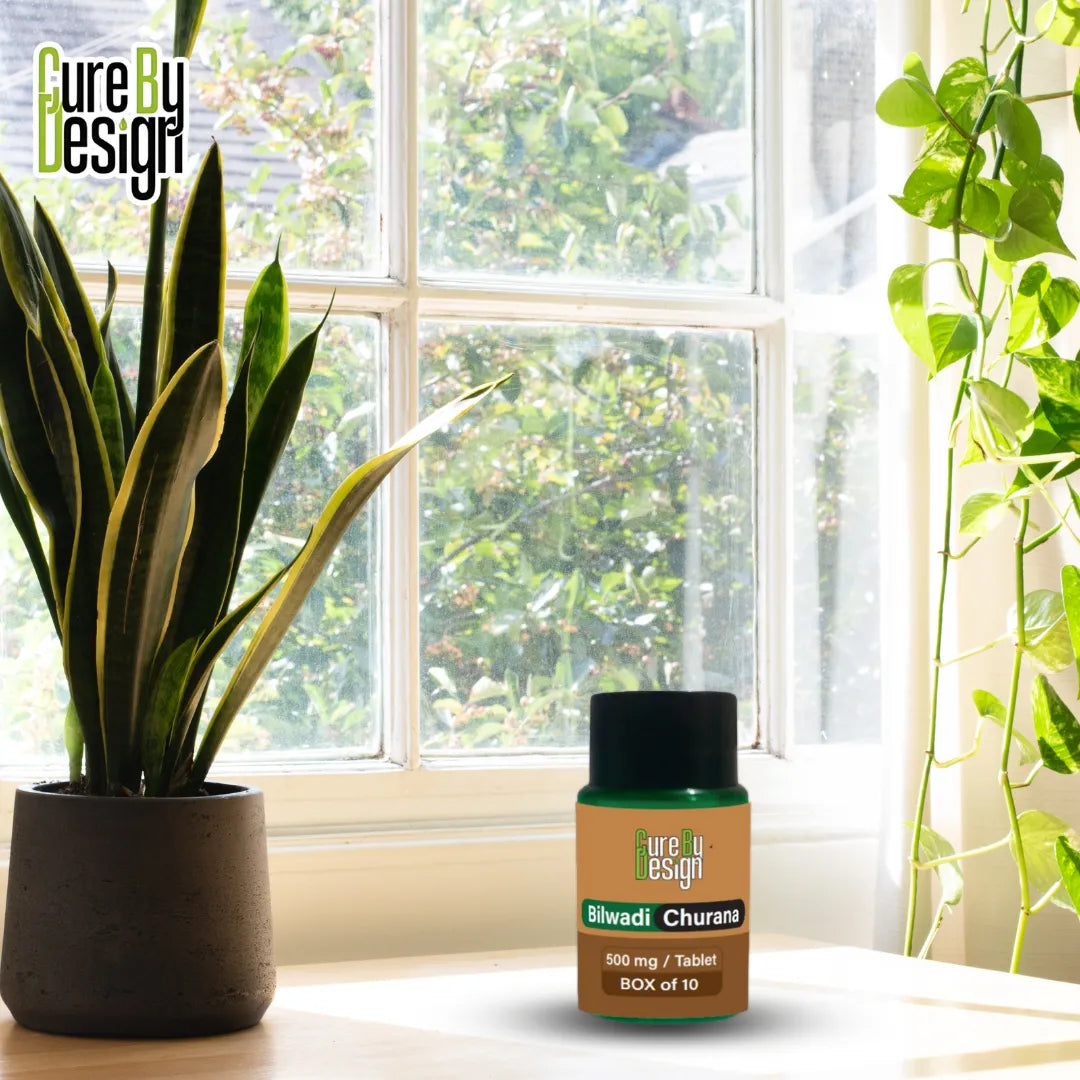 Bottle of 'Cure by Design' bilvadi churana product on a windowsill with plants