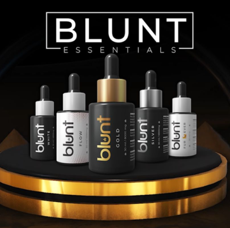 Five Blunt Essentials CBD oil bottles on a black and gold platform.