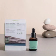 Load image into Gallery viewer, a cbd oil bottle of oil next to a box and rocks.
