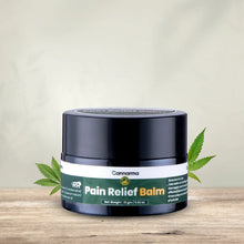 Load image into Gallery viewer, Cannarma Pain Relief Balm container on a wooden surface with leaves in the background.
