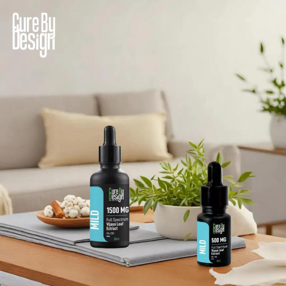 Two bottles of 'Cure By Design' on a table with a living room background