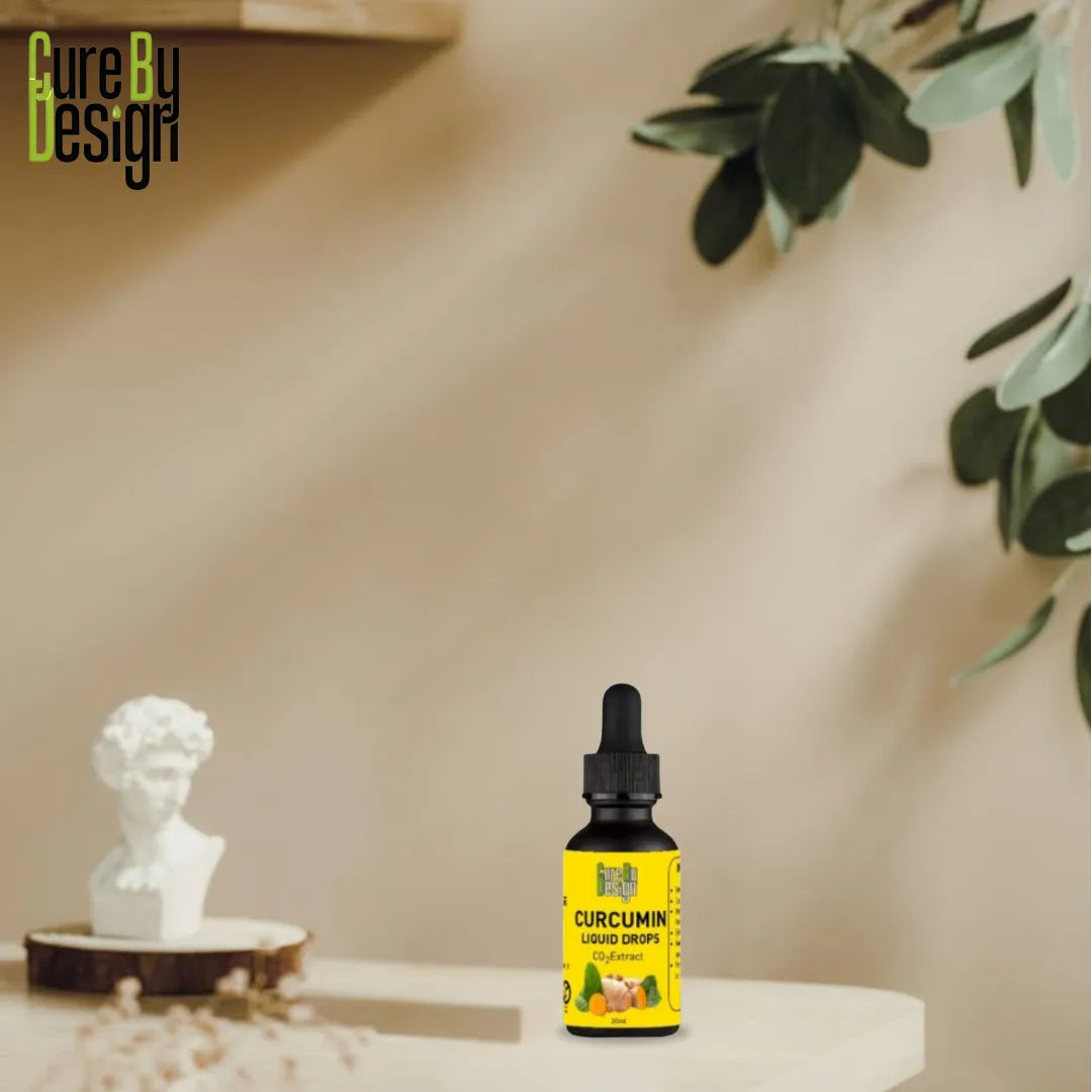 Bottle of Curcumin liquid drops on a table with decorative elements and 'Cure By Design' branding.