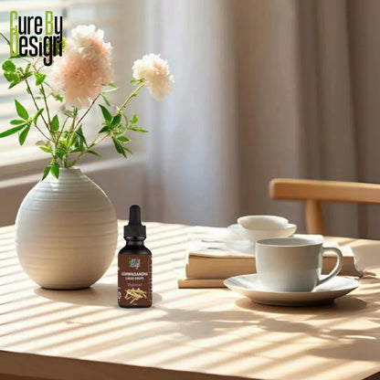 Cure By Design bottle on a table with a vase of flowers and cups.