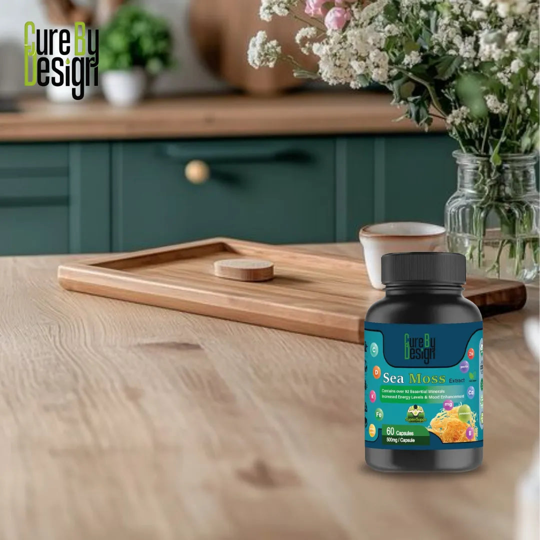 Cure By Design: Seamoss Extract 500mg | 60 Capsules bottle on a wooden table with a kitchen background