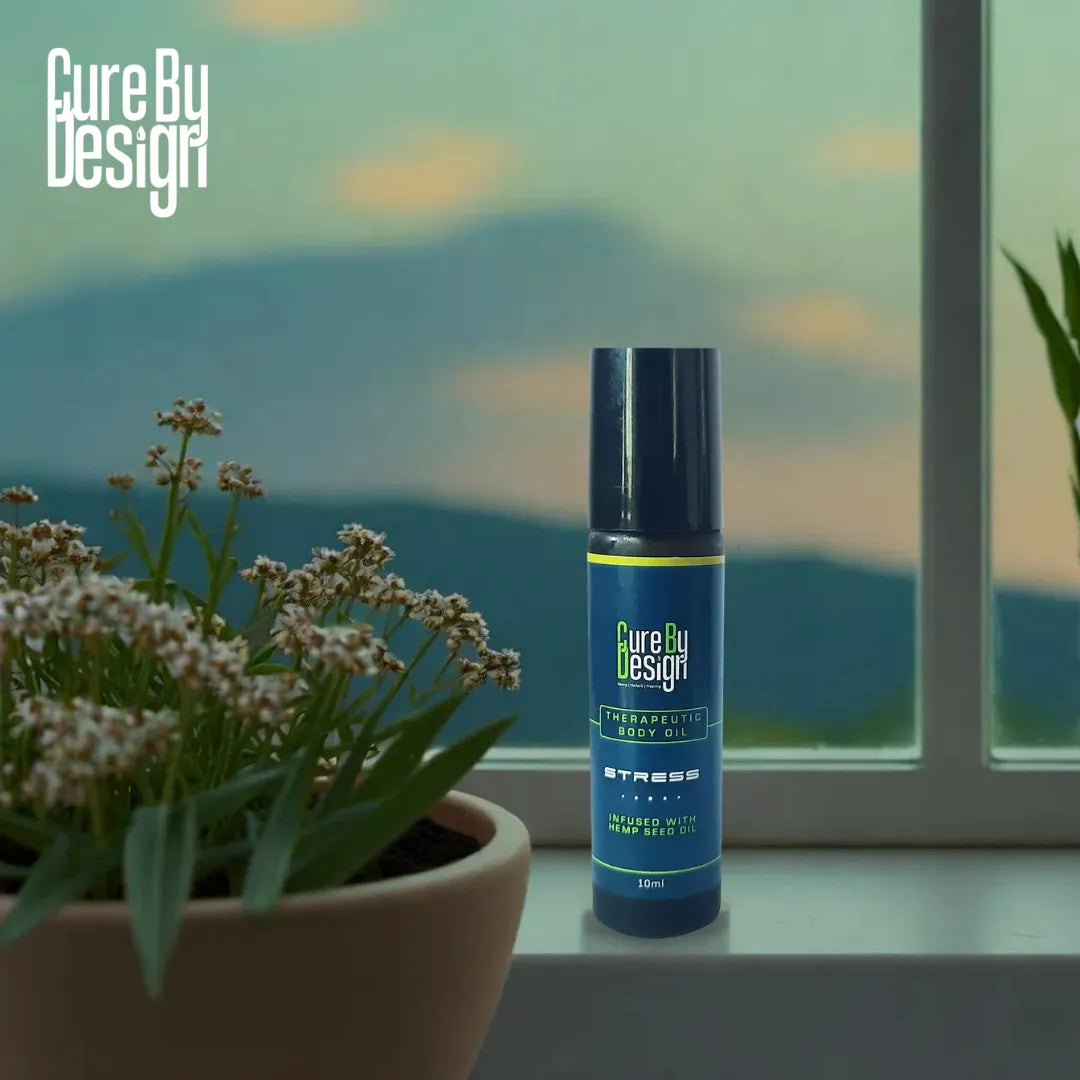 Cure By Design body oil for stress bottle on a windowsill with a scenic background