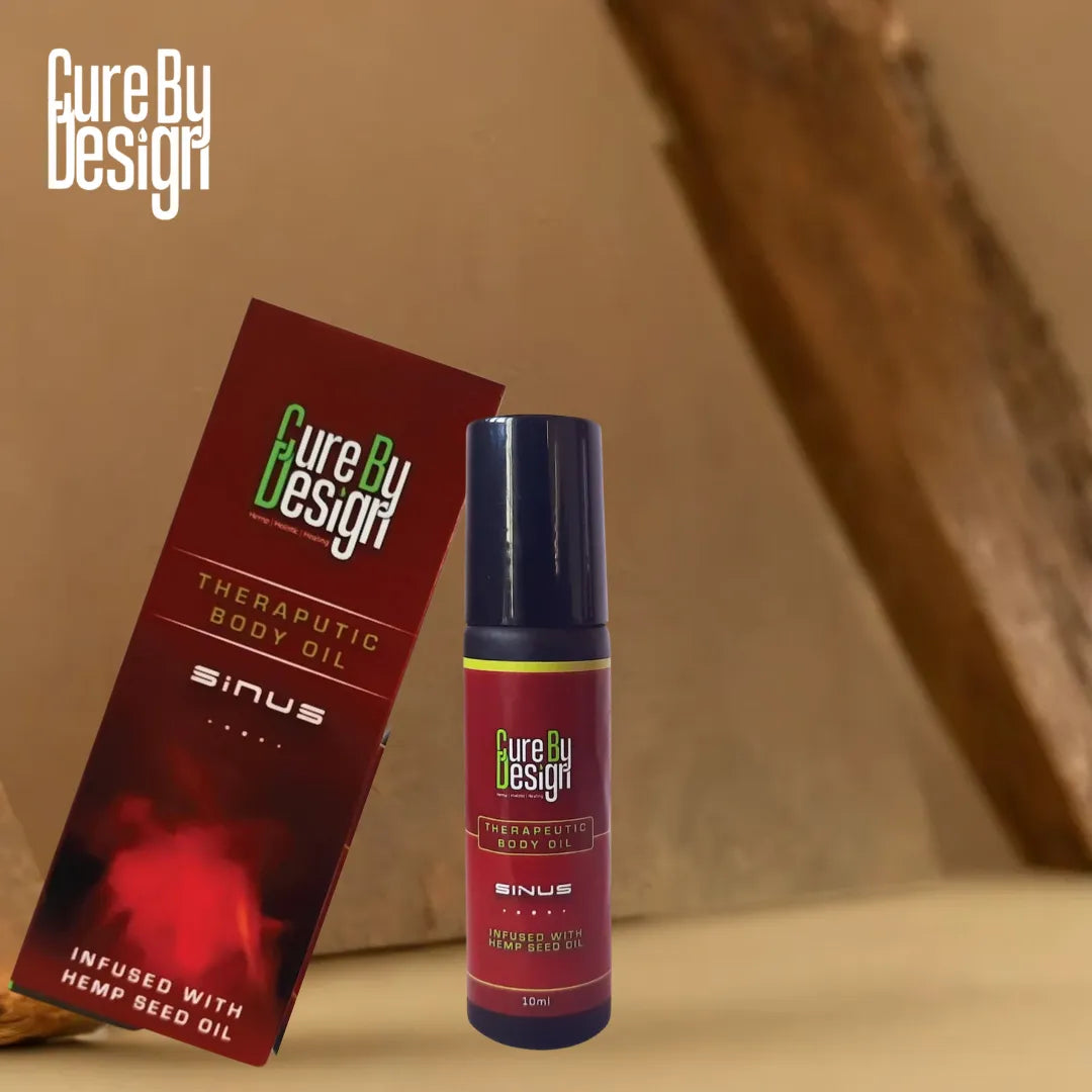 Cure By Design therapeutic body oil packaging on a wooden surface