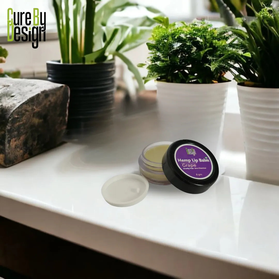 Hemp lip balm with a purple label on a white surface with plants in the background
