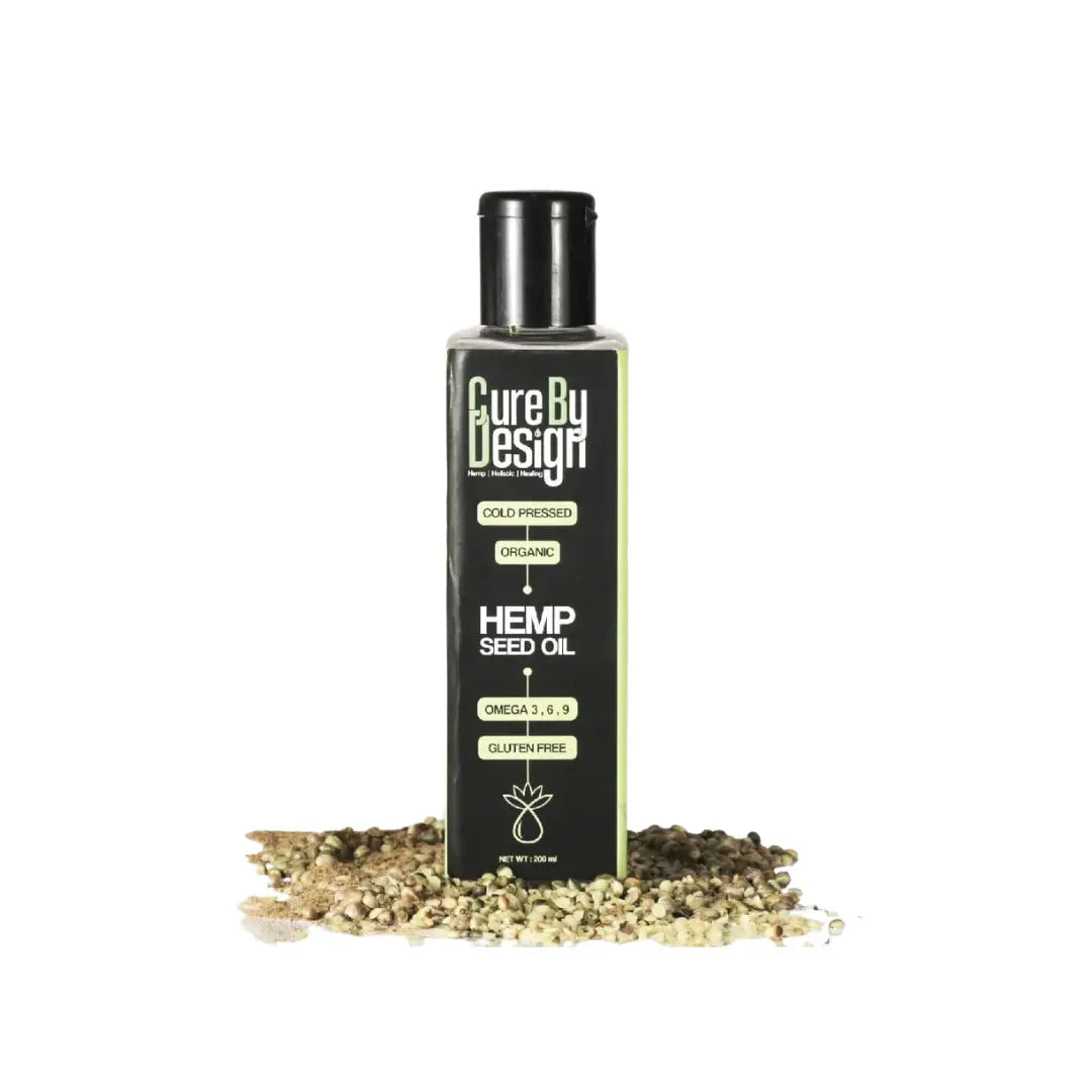 Bottle of Cure By Design Hemp Seed Oil with hemp seeds on a white background
