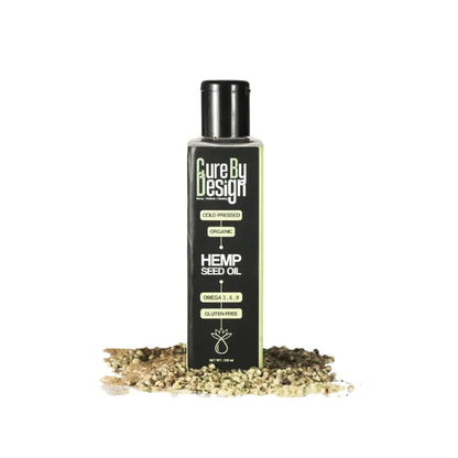 Bottle of Cure By Design Hemp Seed Oil with hemp seeds on a white background