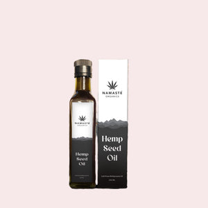 Namaste Organics hemp seed oil bottle and packaging on a light pink background