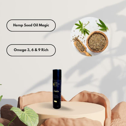 Hemp seed oil product display with a dark blue lip balm tube and text stating "Hemp Seed Oil Magic" and "Omega 3, 6 & 9 Rich," alongside an image of hemp seeds and leaves.

